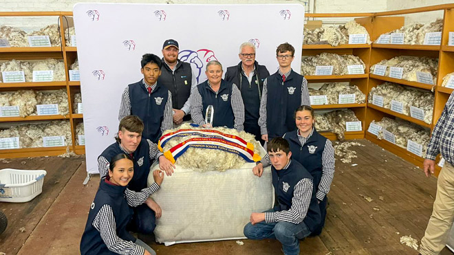South Australian high school students holding a champion wool fleece and award certificates at the School Merino Wether Challenge.