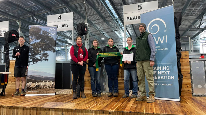Scottsdale High School students from Tasmania displaying Grand Champion ribbons with their Merino sheep.