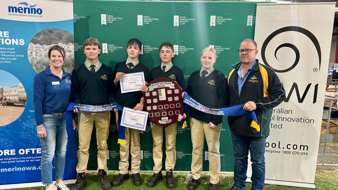 WA College of Agriculture students from Harvey posing with their supreme champion pen of Merino sheep and trophies.